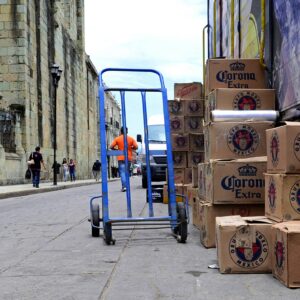 blue hand truck beside cardboard boxes